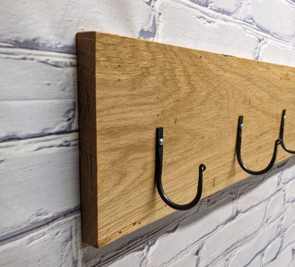 Forged coat hooks on rustic oak